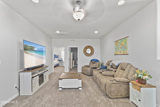 carpeted living room featuring ceiling fan