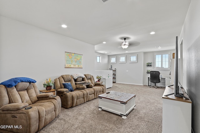 carpeted living room with ceiling fan