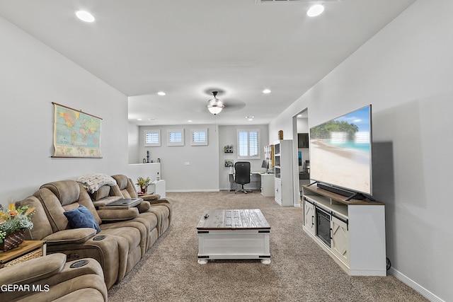 carpeted living room with ceiling fan