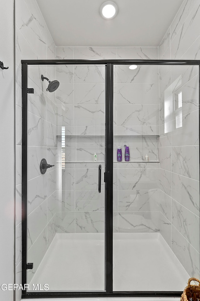 bathroom with a shower with shower door