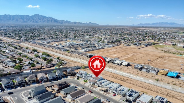 birds eye view of property with a mountain view