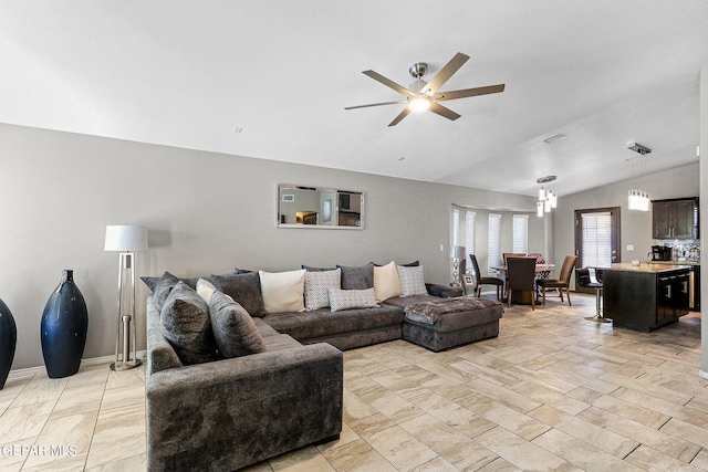 living room with light hardwood / wood-style floors, vaulted ceiling, and ceiling fan