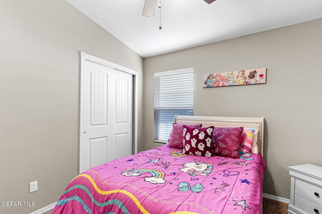 bedroom featuring lofted ceiling, ceiling fan, and a closet