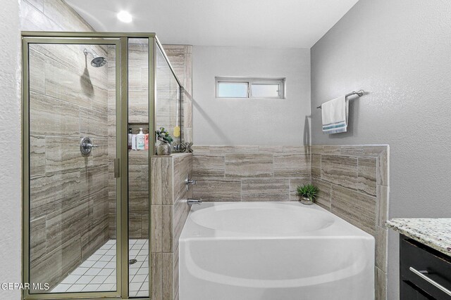 bathroom with shower with separate bathtub and vanity