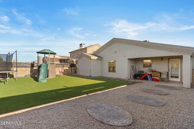 view of yard with a playground, a trampoline, and a patio area