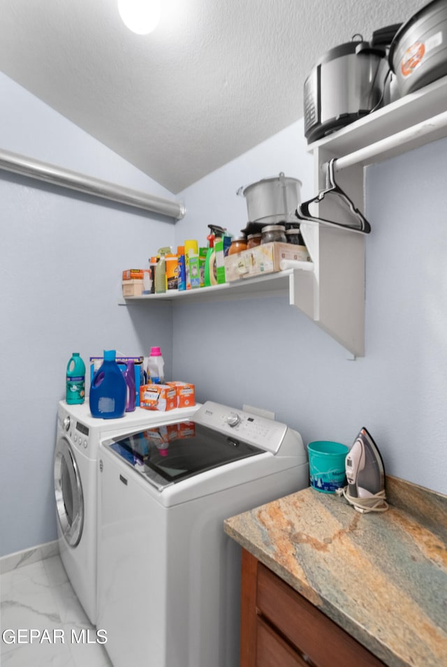 laundry area with a textured ceiling and independent washer and dryer