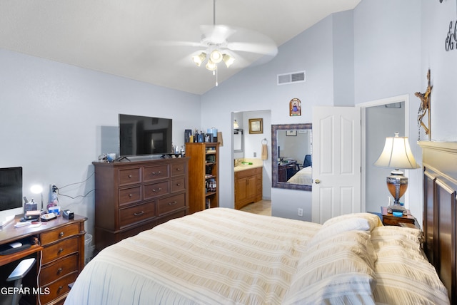 bedroom featuring ceiling fan, ensuite bath, and vaulted ceiling