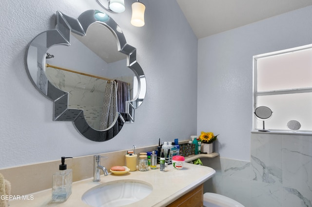 bathroom with toilet, lofted ceiling, vanity, and a shower with shower curtain