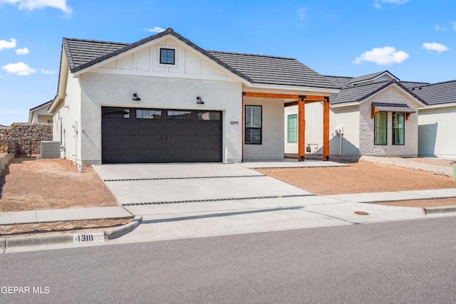 modern farmhouse style home with a garage and central AC unit