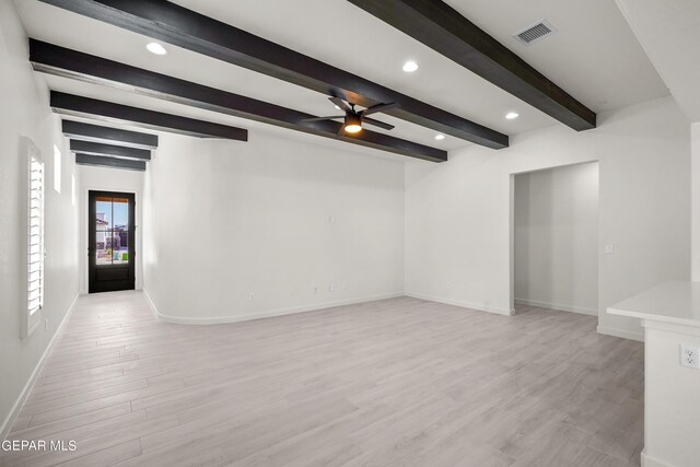 spare room featuring ceiling fan, beamed ceiling, and light wood-type flooring