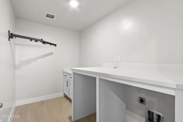 laundry area featuring light hardwood / wood-style flooring and hookup for an electric dryer