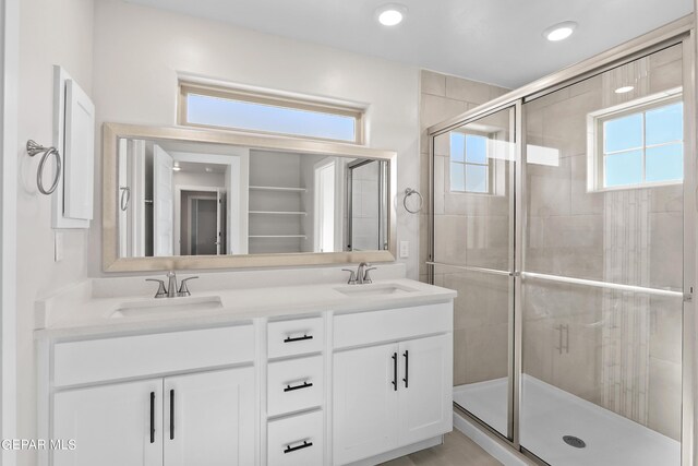 bathroom with walk in shower and vanity