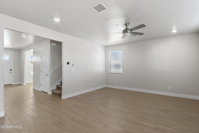 empty room with light hardwood / wood-style flooring and ceiling fan