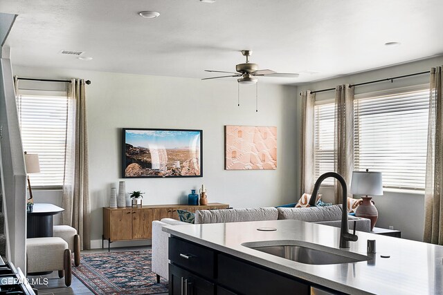 kitchen featuring ceiling fan and sink