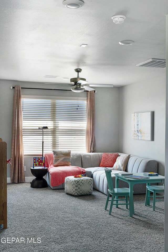 living room with carpet flooring and ceiling fan