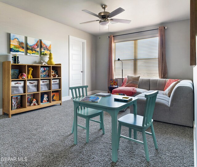 carpeted dining room with ceiling fan