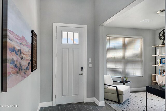 entryway with dark hardwood / wood-style flooring