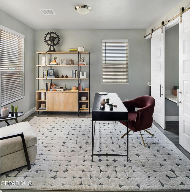 home office featuring a barn door