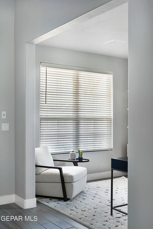 sitting room featuring dark hardwood / wood-style floors and a healthy amount of sunlight