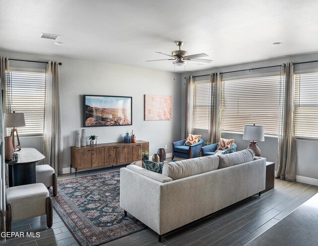 living room with ceiling fan and dark hardwood / wood-style flooring