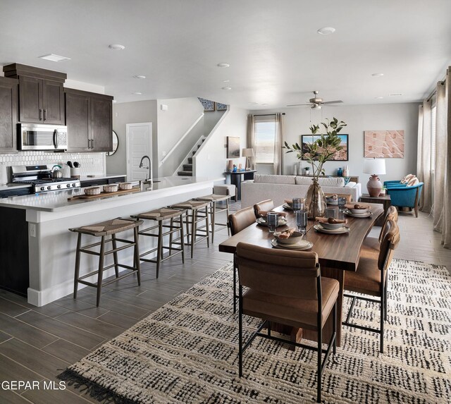 dining area with ceiling fan and dark wood-type flooring