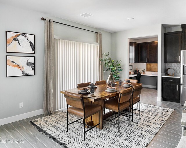 dining space featuring light wood-type flooring