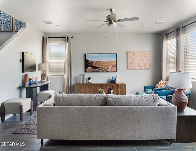 living room with ceiling fan and dark hardwood / wood-style floors