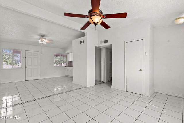 spare room with a textured ceiling and ceiling fan