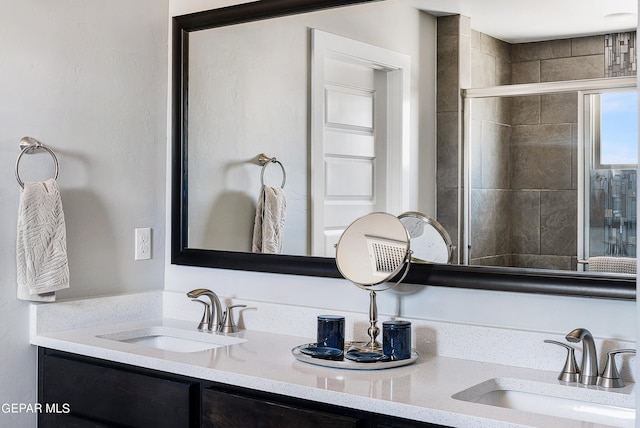 bathroom featuring vanity and an enclosed shower