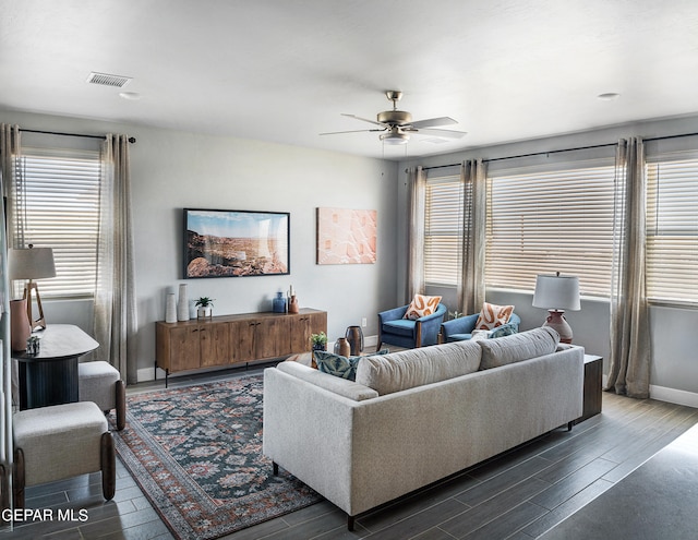 living room featuring ceiling fan and dark hardwood / wood-style floors