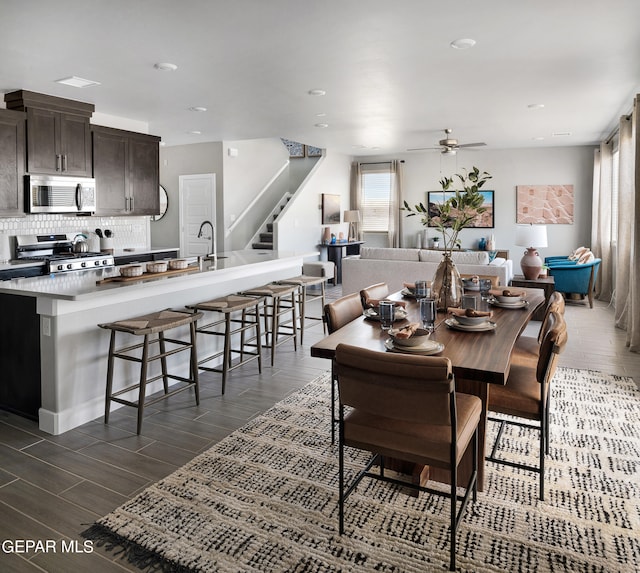 dining space with ceiling fan and dark hardwood / wood-style flooring