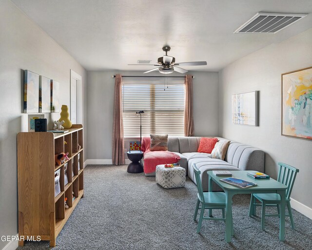 carpeted living room with ceiling fan