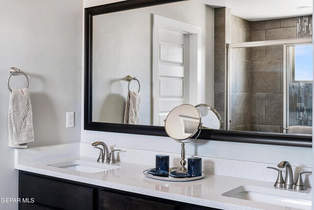 bathroom with walk in shower and vanity