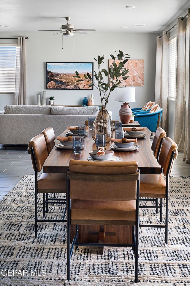 dining space featuring wood-type flooring, ceiling fan, and a wealth of natural light