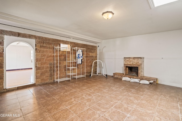 unfurnished living room featuring a brick fireplace