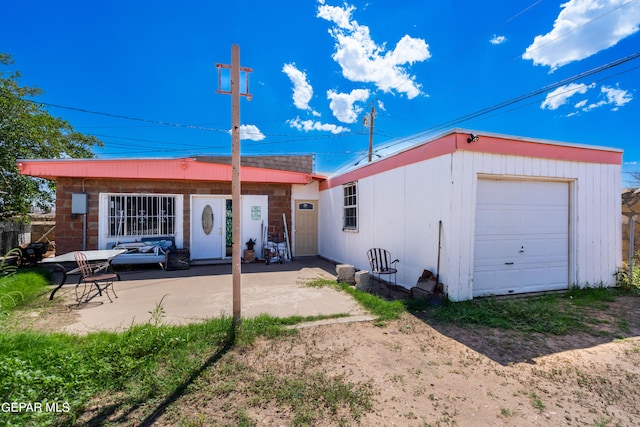 rear view of house featuring a garage