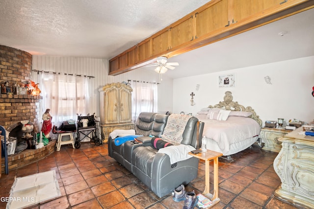 bedroom featuring a textured ceiling, a fireplace, and ceiling fan