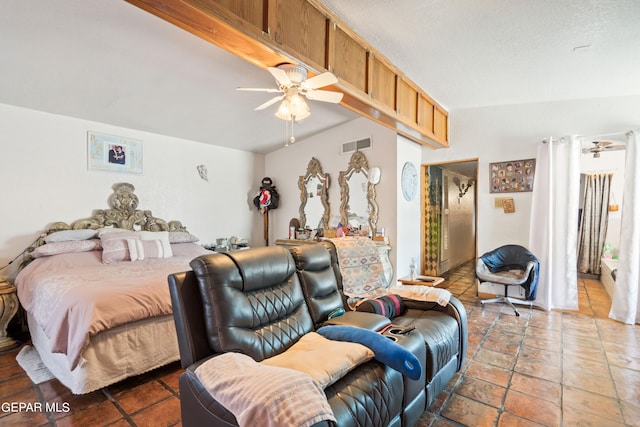 bedroom featuring dark tile patterned flooring, vaulted ceiling, and ceiling fan