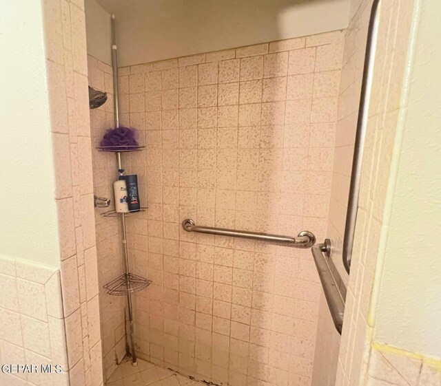 bathroom with tiled shower