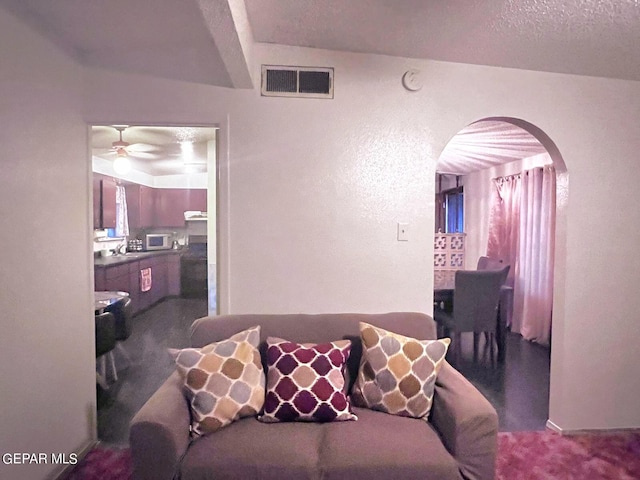 living room with carpet flooring and ceiling fan