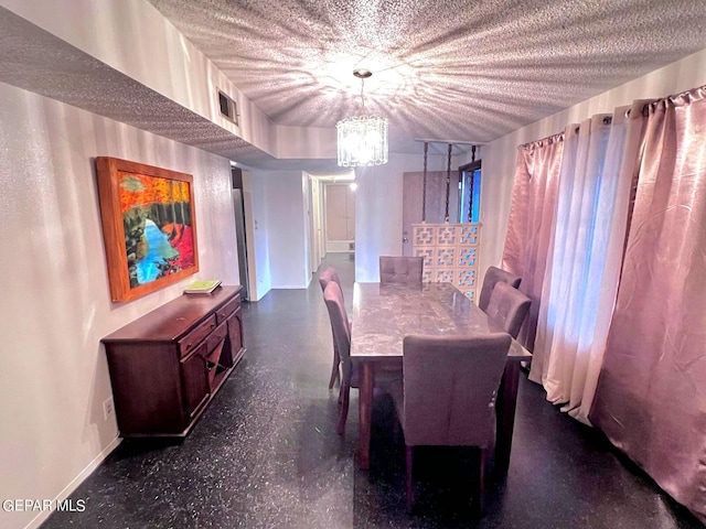 dining room featuring a chandelier and a textured ceiling