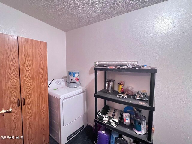 laundry room with washer / dryer and a textured ceiling