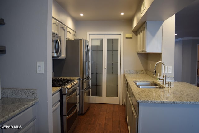 kitchen featuring white cabinets, stainless steel appliances, ornamental molding, dark hardwood / wood-style floors, and sink