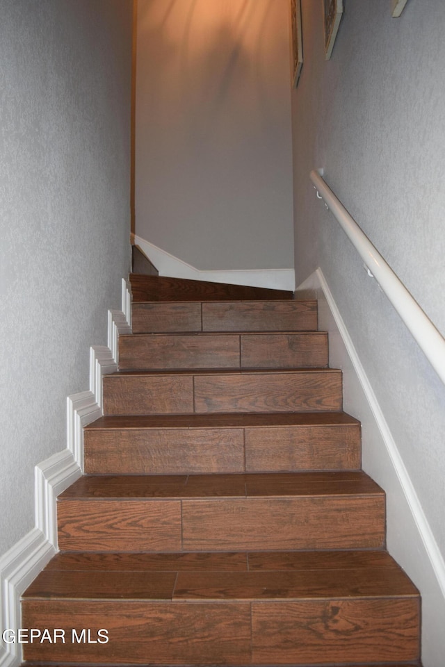 stairs featuring hardwood / wood-style floors