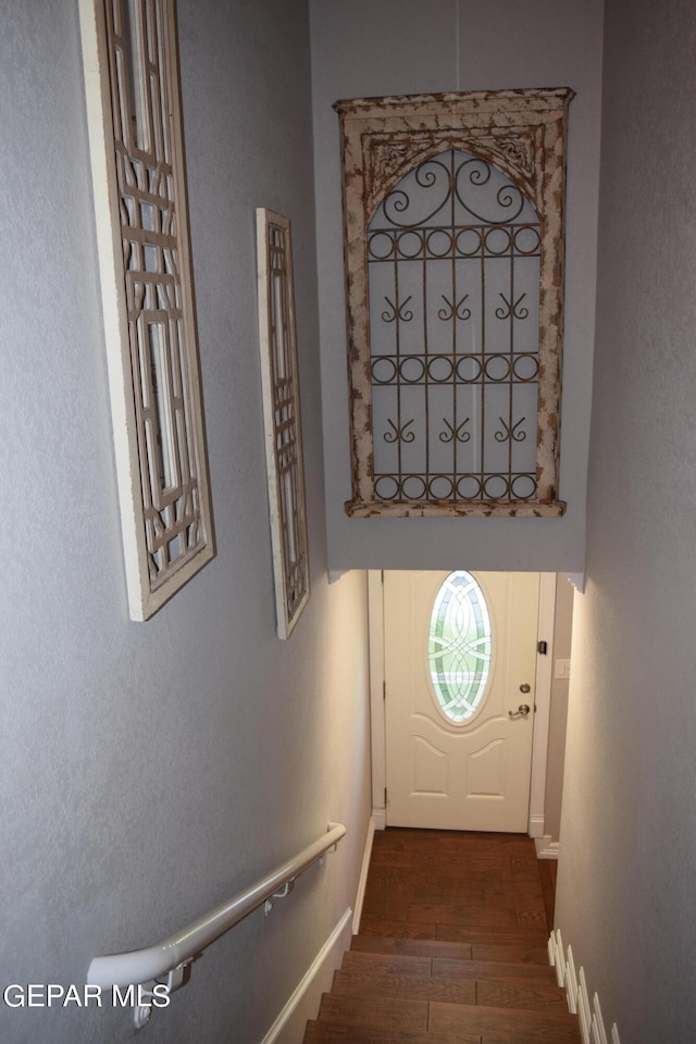 doorway with dark wood-type flooring