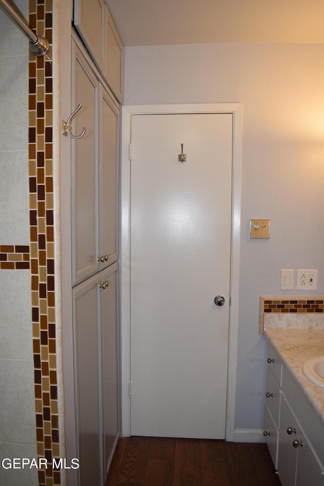 bathroom with vanity, a shower, and hardwood / wood-style floors