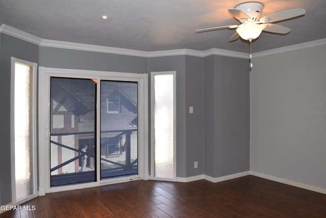 spare room featuring ornamental molding, ceiling fan, and dark wood-type flooring