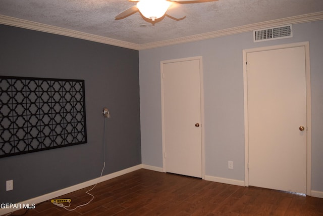 interior space with a textured ceiling, ornamental molding, dark wood-type flooring, and ceiling fan