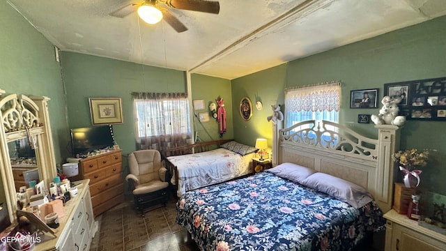 bedroom with a textured ceiling and ceiling fan