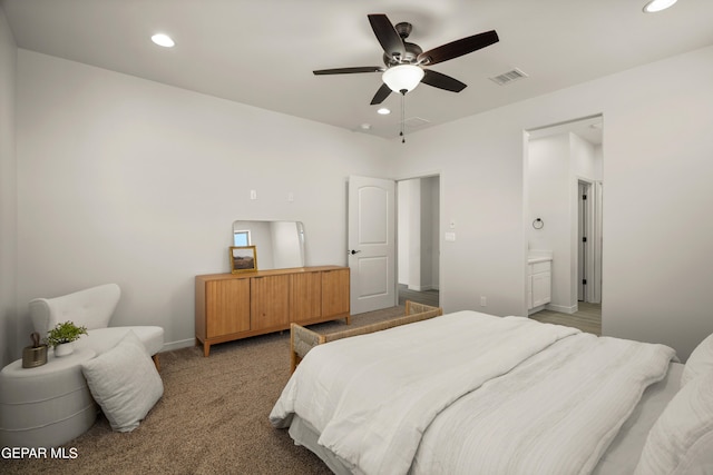 bedroom with ceiling fan, carpet floors, and ensuite bathroom